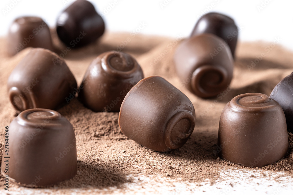 Chocolate bonbons and cocoa powder background. Close up Chocolate bonbons and cocoa powder background. Close up