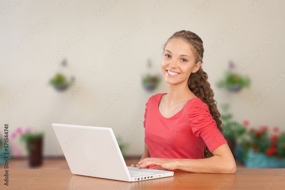 Young happy student sitting at home with computer Young happy student sitting at home with computer