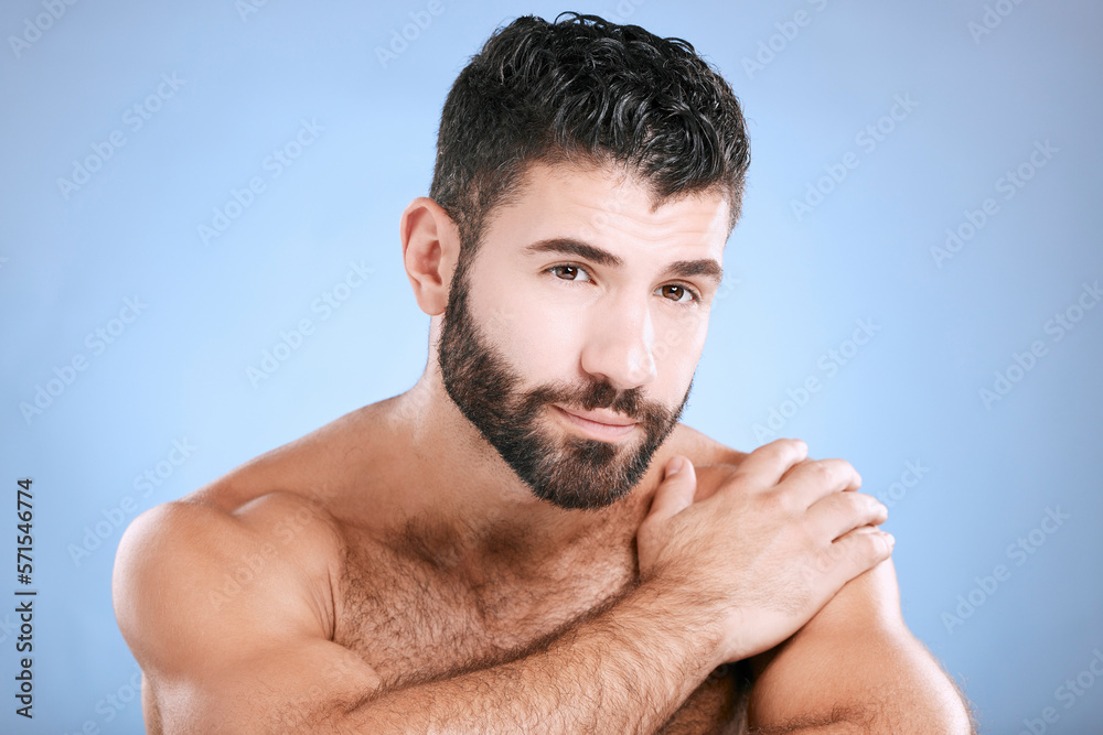 Obraz premium Skincare, portrait and man relax in studio for grooming, hygiene and cosmetics on blue background. Face, beauty and guy skin model satisfied with luxury, pamper and treatment, body care and isolated