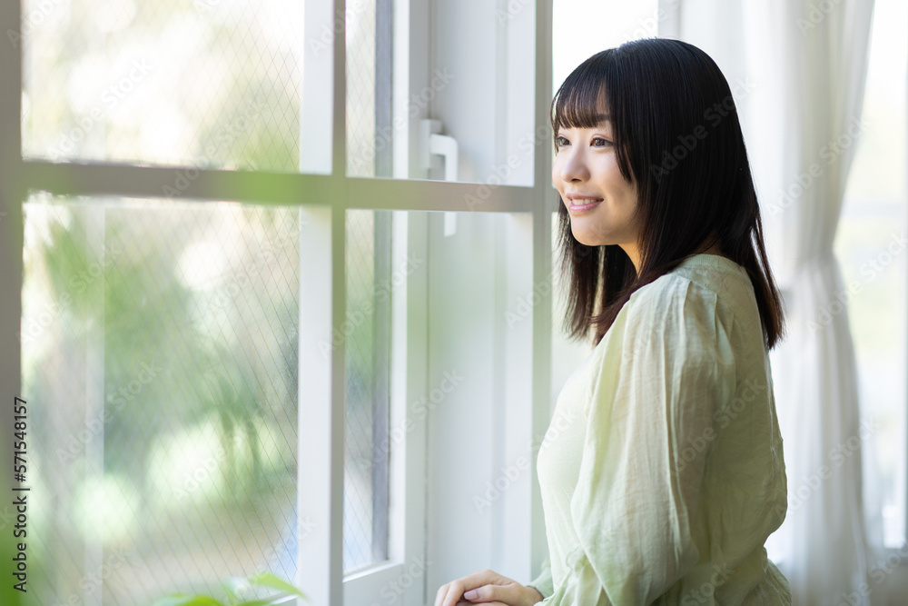 窓際に立つ女性 窓際に立つ女性