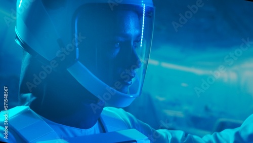 Wallpaper Mural A woman astronaut in a space suit aboard the orbital station. A young female cosmonaut pilots a spaceship. Galactic travel and science concept. Torontodigital.ca