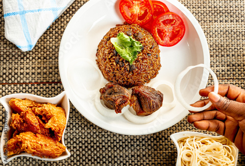 jollof with red chili paste and chicken and meat