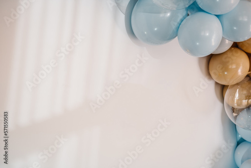 Details. Photo-wall decoration space  place for text on white background. Arch decorated with blue  brown  grey balloons. Wedding reception. Trendy decor. Celebration baptism concept. Birthday party.