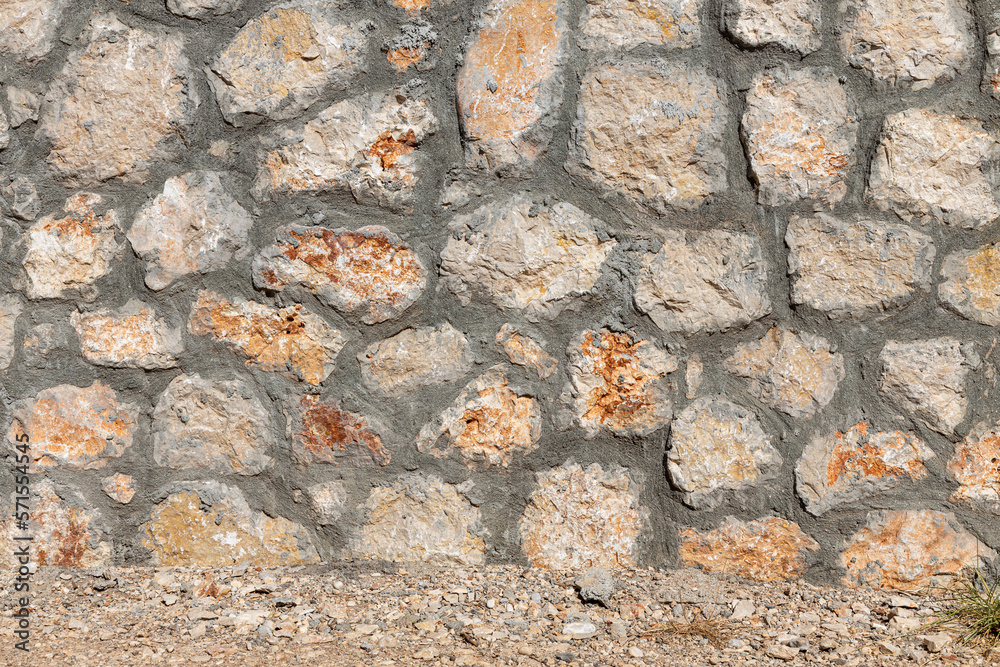 Beautiful texture of an old wall from orange stones with cracks Beautiful texture of an old wall from orange stones with cracks