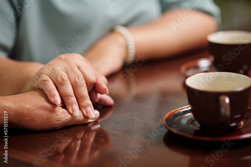 Senior woman touching hand of her husband, expressing love and support