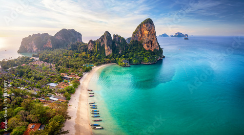 Panoramic aerial view of the beautiful Railay beach, Krabi, Thailand, lush rain forest and emerald sea during morning sunrise without people photo