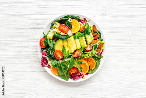 Healthy vegetarian bowl - green salad with avocado and tomatoes