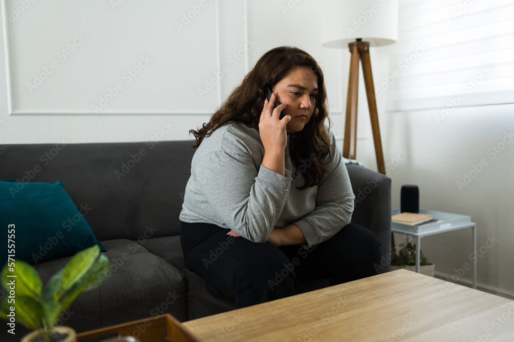 Sad woman talking on the phone feeling lonely Sad woman talking on the phone feeling lonely