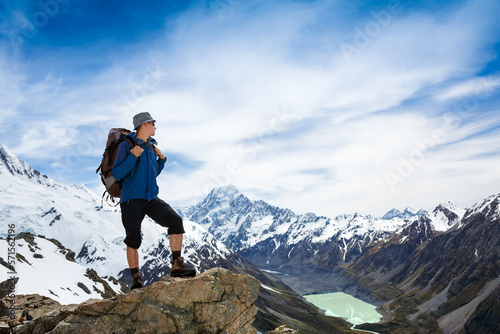 Hiker with backpack on the mountain top. Sport and active life concept