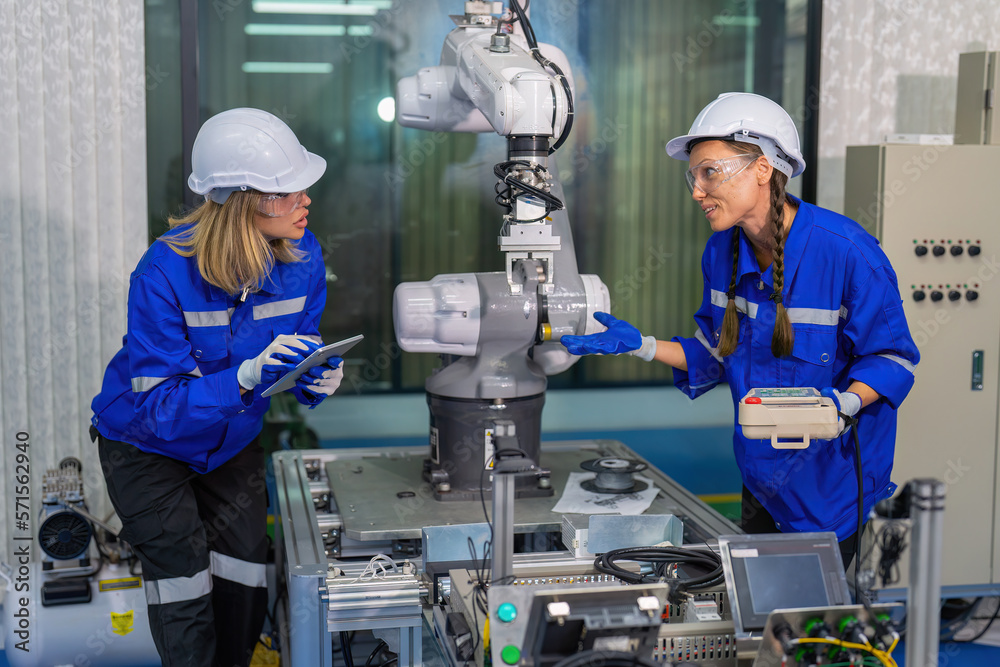 Female robotic factory workers use tablet pc quality checking Circuit Boards after assembly Female robotic factory workers use tablet pc quality checking Circuit Boards after assembly