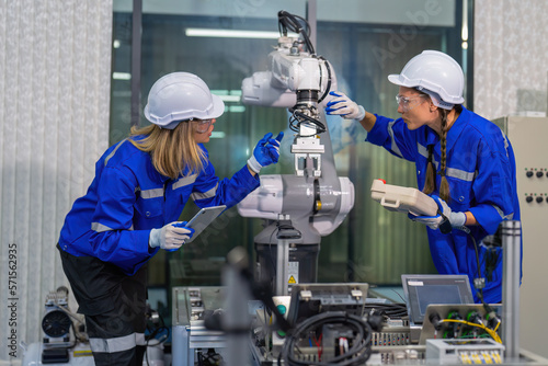 Female robotic factory workers use tablet pc quality checking Circuit Boards after assembly