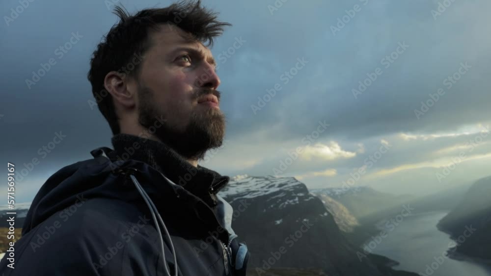 Confident person reached Trolltunga in Norway, close up motion view Confident person reached Trolltunga in Norway, close up motion view