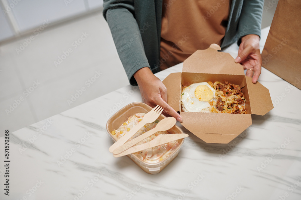 Woman Opening Box of Food
