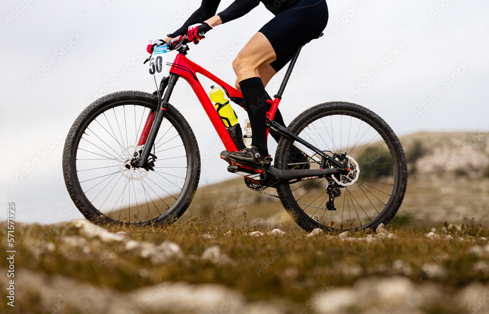 close up male cyclist on mountainbike riding on mountain trail close up male cyclist on mountainbike riding on mountain trail