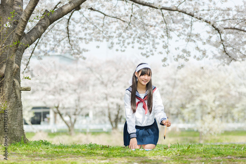 桜の樹の下で書道する女子校生 photo