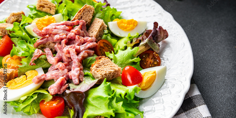 Vosges salad bacon, egg, croutons, lettuce, salad dressing vinaigrette Lorraine cuisine healthy meal food snack on the table copy space food background rustic top view