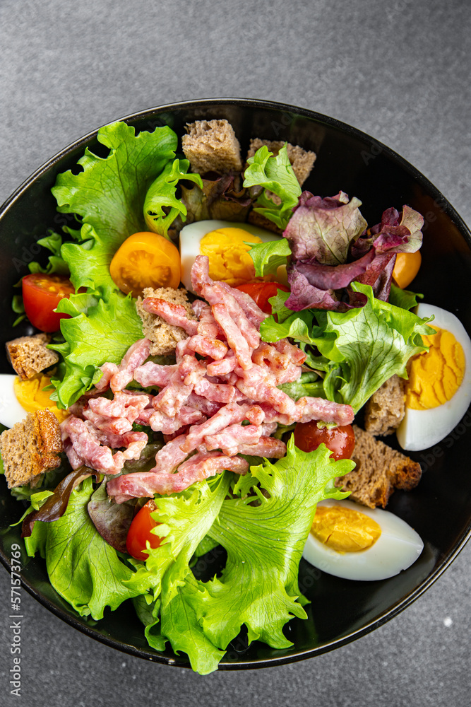 Vosges salad bacon, egg, croutons, lettuce, salad dressing vinaigrette Lorraine cuisine healthy meal food snack on the table copy space food background rustic top view Vosges salad bacon, egg, croutons, lettuce, salad dressing vinaigrette Lorraine cuisine healthy meal food snack on the table copy space food background rustic top view