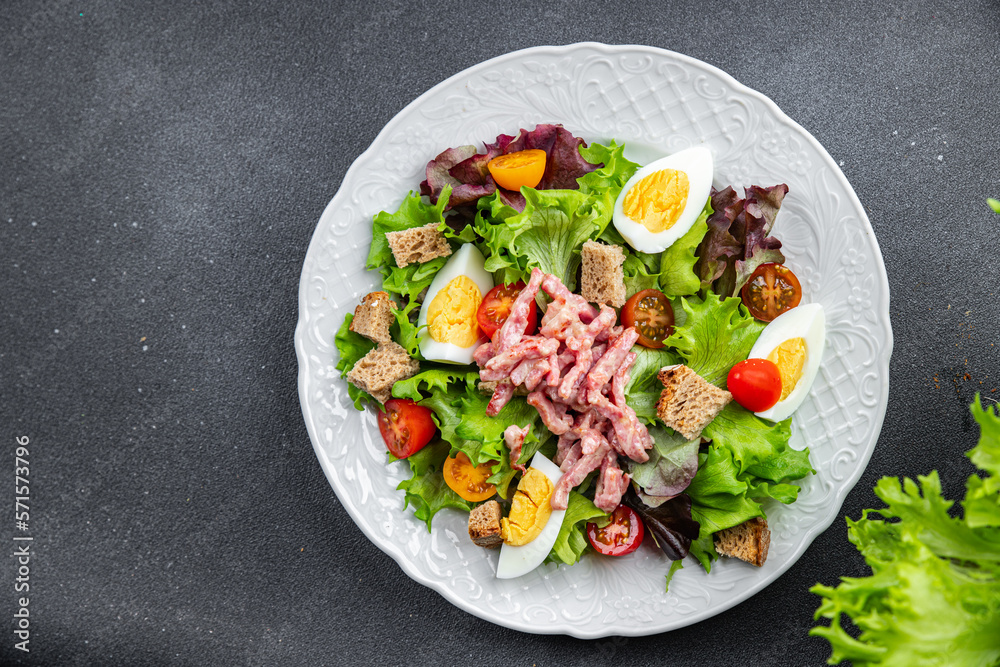 Vosges salad bacon, egg, croutons, lettuce, salad dressing vinaigrette Lorraine cuisine healthy meal food snack on the table copy space food background rustic top view Vosges salad bacon, egg, croutons, lettuce, salad dressing vinaigrette Lorraine cuisine healthy meal food snack on the table copy space food background rustic top view