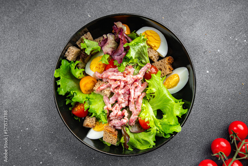 Vosges salad bacon, egg, croutons, lettuce, salad dressing vinaigrette Lorraine cuisine healthy meal food snack on the table copy space food background rustic top view