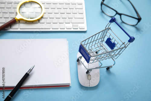 Shopping cart with a computer keyboard and business objects.