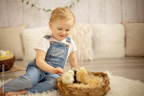 Cute child at home with little newborn chicks, enjoying, cute kid and animal friend in sunny room