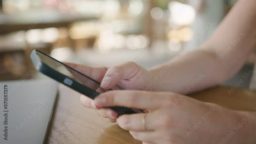 Business freelance woman using smartphone for browsing Internet, reading and texting while sitting on table in cafe. Lifestyle, working at coffee shop concepts. Social media. Business freelance woman using smartphone for browsing Internet, reading and texting while sitting on table in cafe. Lifestyle, working at coffee shop concepts. Social media.