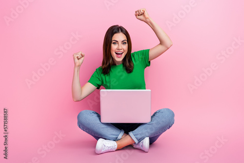 Full length photo of impressed lucky girl wear green crop top rising fists playing egame modern device isolated pink color background © deagreez
