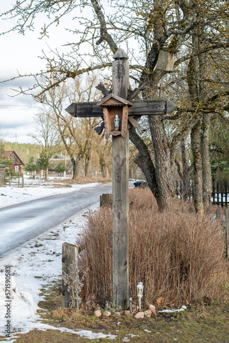 Beautiful old traditional wooden cross in the village of Margionys, Dzūkija or Dainava region, Lithuania, in winter or spring, vertical photo