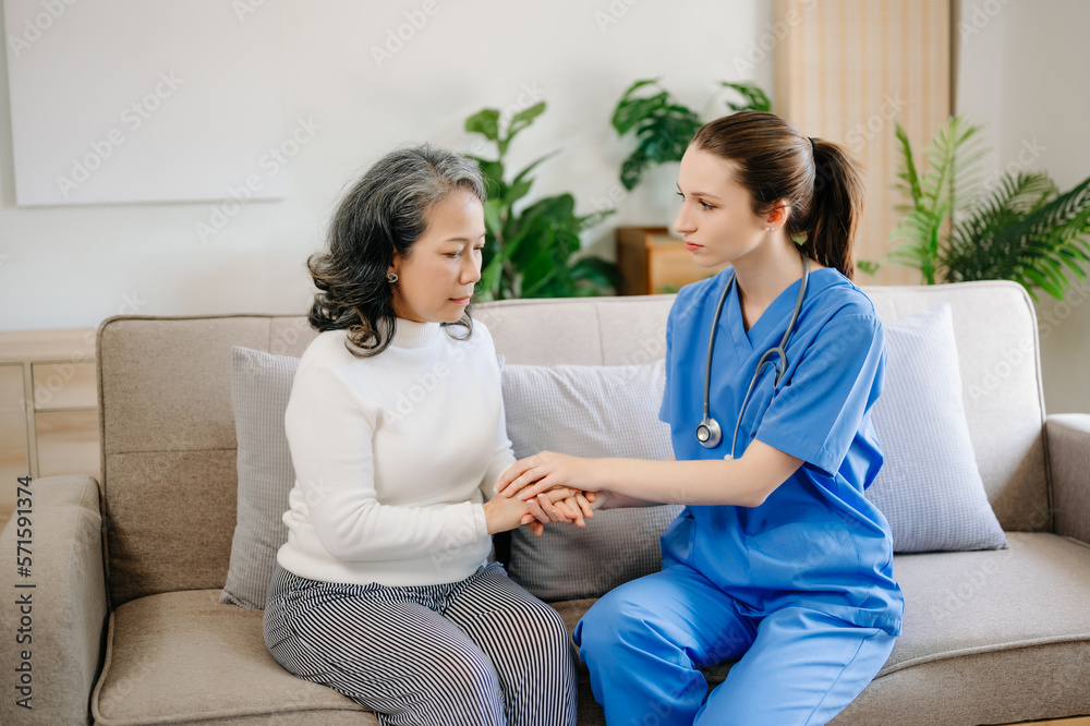 Asian female hands touching old female hand Helping hands take care of the elderly concept in hospital. Asian female hands touching old female hand Helping hands take care of the elderly concept in hospital.