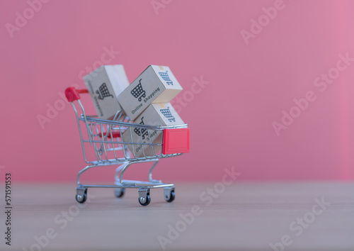 Mini shopping cart contain paper box using as e-commerce, online shopping and business marketing concept