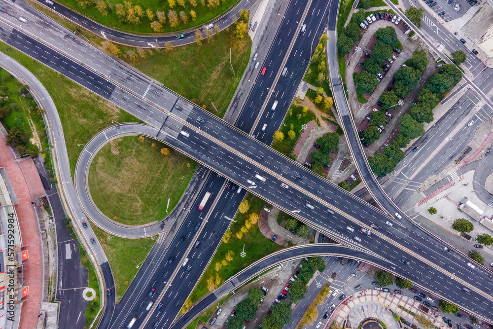 Aerial view of a busy road intersection with vehicles driving along Benfica Soccer stadium in Benfica district at twilight, Lisbon, Portugal. Aerial view of a busy road intersection with vehicles driving along Benfica Soccer stadium in Benfica district at twilight, Lisbon, Portugal.