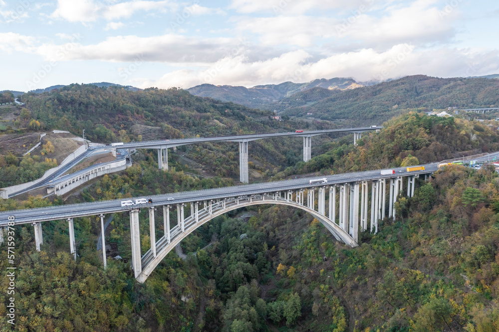 Aerial view of vehicles driving on the highway viaduct near Florence, Tuscany, Italy. Aerial view of vehicles driving on the highway viaduct near Florence, Tuscany, Italy.