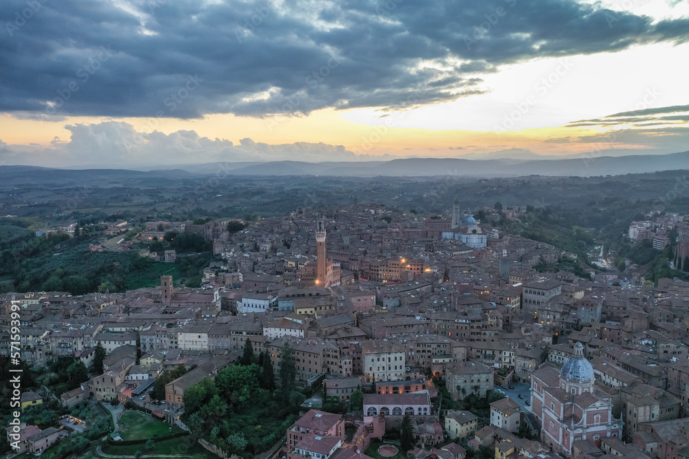 Aerial view of Siena old town with Piazza del Campo main square at sunset, Tuscany, Italy. Aerial view of Siena old town with Piazza del Campo main square at sunset, Tuscany, Italy.
