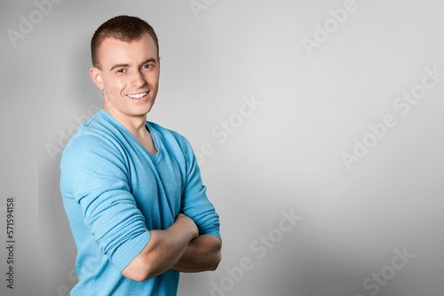 Happy young man posing on background