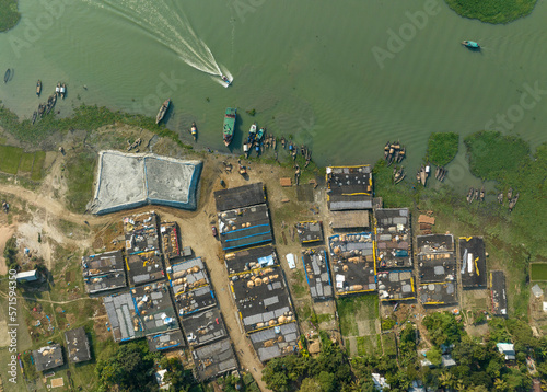 Aerial view of people working in a fish market drying fish at Lalpur Launch Ghat along Meghna River, Chattogram, Bangladesh. photo