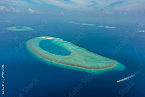 Aerial view of a sailing boat along the Raa Atoll coastline, Maldives archipelagos. photo