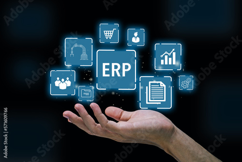 ERP,Enterprise Resource Planning.Hand of businessman holding ERP icon with black background.