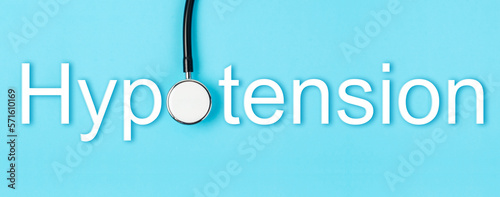 The Hypotension text and medical stethoscope on blue background, Screening for Hypotension disease concepts. photo