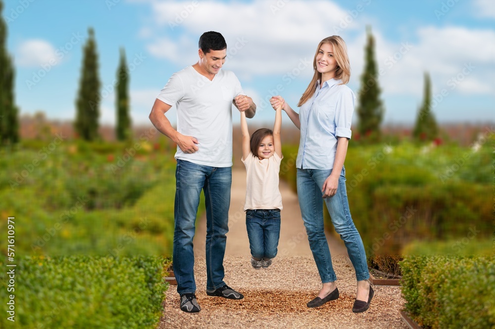 Beautiful young family posing on outdoor background