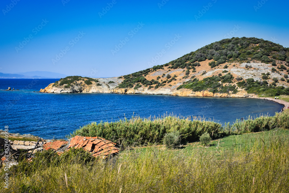 A virgin bay in İzmir Foça. Aegean sea, maquis covered Aegean mountains, a destroyed stone house and natural vegetation. izmir ancient phokaia
