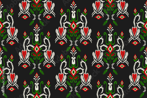 Ikat floral paisley embroidery on black background, traditional oriental geometric pattern. Aztec abstract pattern design for textures, fabrics, wraps, clothing.
