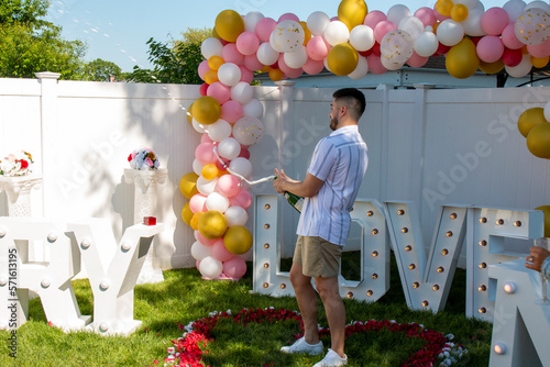 Billede på lærred Just engaged man popping a bottle of champaign after she said yes