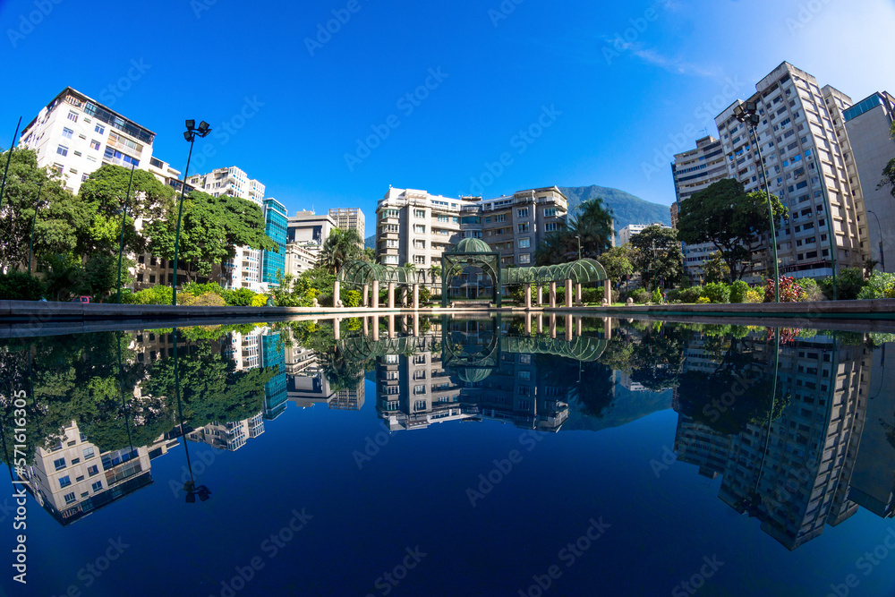 North view of Plaza Altamira in Chacao, Caracas Venezuela. Reflecting pool showing Edificio Altamira, one of the oldest buildings in the area. 