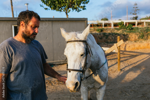 Man with a horse outdoors at daytime.