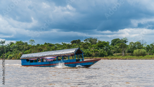 A motorized wooden boat underway on the Amazon River