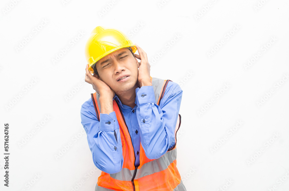stressed over work concept illustrated by asian male construction worker in blue shirt, orange vest and yellow safety helmet with furious, mad, sad, angry expression. overworked concept
