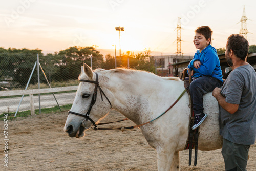 Child with disabilities having fun while enjoying a horseback ride.