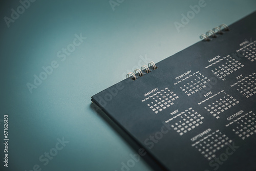 Embroidered red pins on a calendar event Planner calendar,clock to set timetable organize schedule,planning for business meeting or travel planning concept. photo