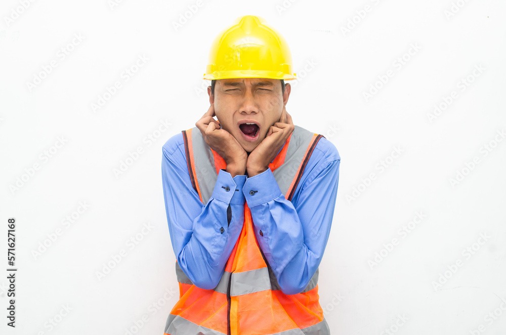 stressed over work concept illustrated by asian male construction worker in blue shirt, orange vest and yellow safety helmet with furious, mad, sad, angry expression. overworked concept stressed over work concept illustrated by asian male construction worker in blue shirt, orange vest and yellow safety helmet with furious, mad, sad, angry expression. overworked concept