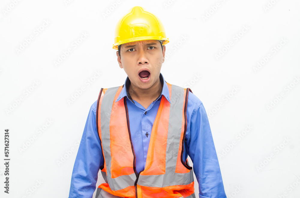 stressed over work concept illustrated by asian male construction worker in blue shirt, orange vest and yellow safety helmet with furious, mad, sad, angry expression. overworked concept stressed over work concept illustrated by asian male construction worker in blue shirt, orange vest and yellow safety helmet with furious, mad, sad, angry expression. overworked concept